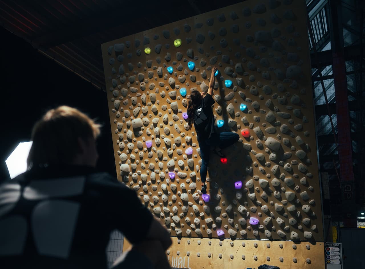 A light up rock climbing wall with LED climbing holds, controlled from the app